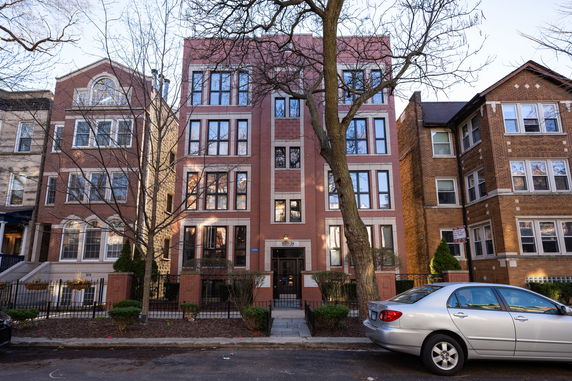 Front view of a multi-story brick apartment building.