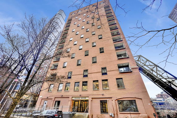 Front view of a multi-story building with brick exterior.