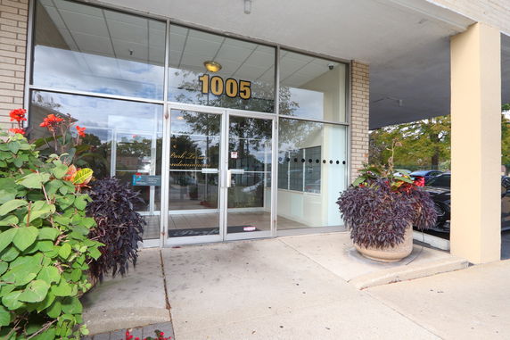 Entrance view of a building with glass doors and large windows.