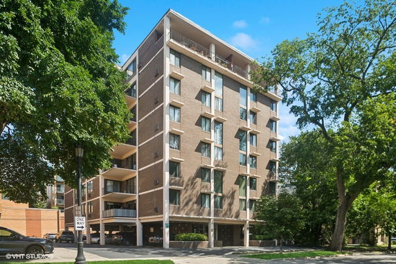 Front view of a multi-story apartment building with balconies.