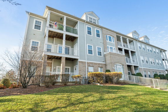 Front view of a multi-story residential building with balconies.