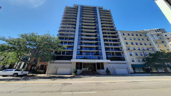 Front view of a multi-story residential building with balconies.