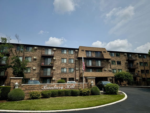 Front view of a multi-story brick apartment building.