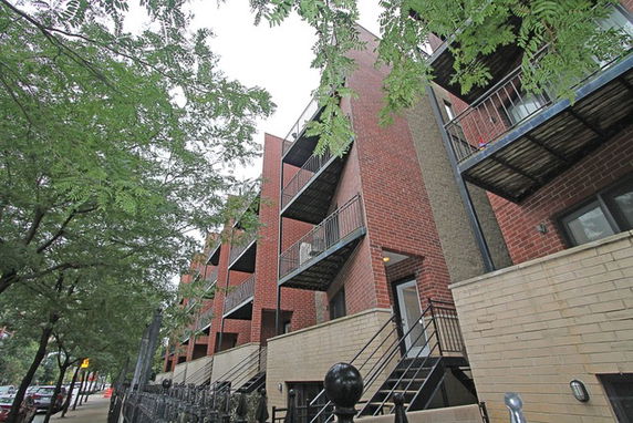 View of a multi-story building with external staircases and balconies.