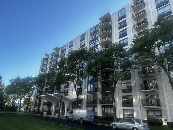 Front view of a multi-story residential building with balconies.