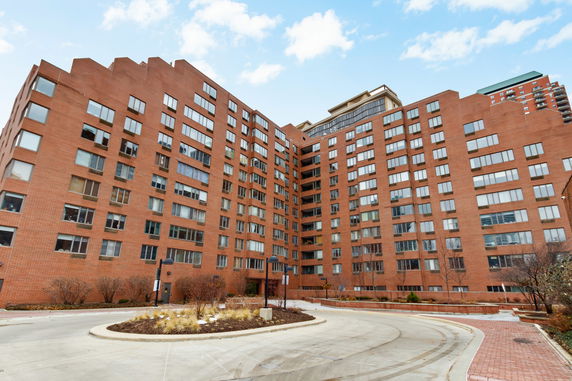 Front view of a multi-story brick apartment building.