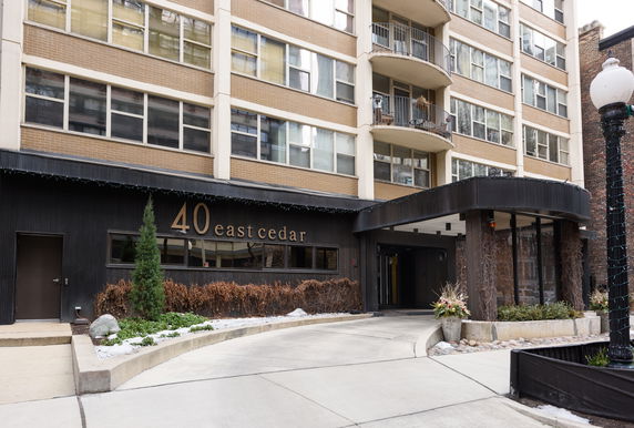 Front view of a multi-story apartment building with balconies.