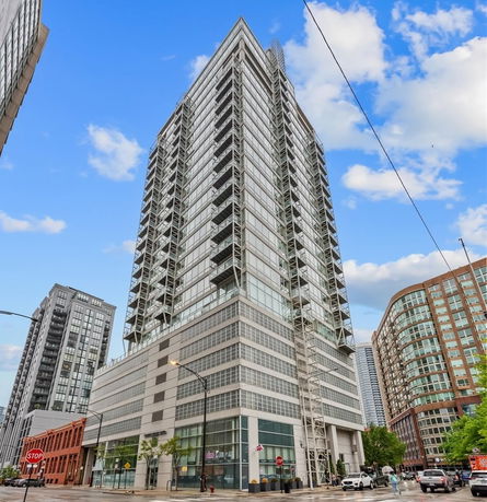 Front view of a modern high-rise building with glass windows and multiple stories.