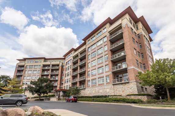 Front view of a multi-story residential building with balconies.