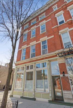 Front view of a multi-story brick building.