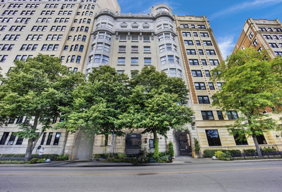 Front view of a multi-story building with ornate architectural details.