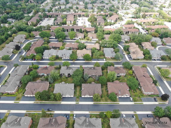 Aerial view of a suburban neighborhood with houses and streets.