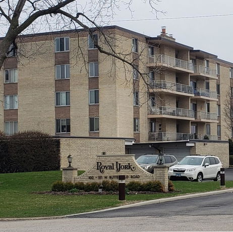 Front view of a multi-story residential building with balconies.
