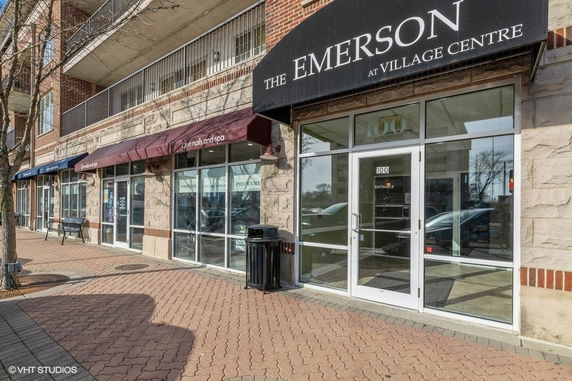 Front view of a commercial building with multiple storefronts and glass entrances.