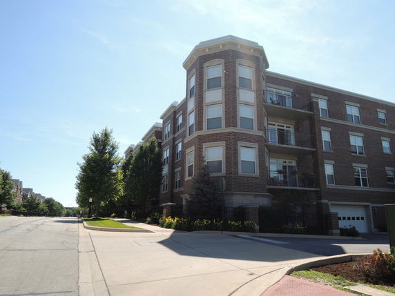 Front view of a multi-story brick apartment building.