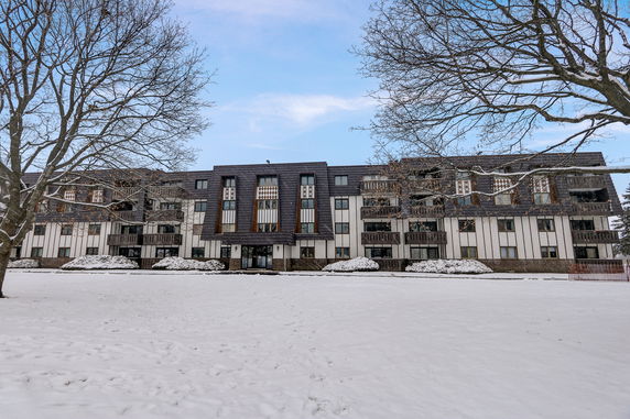 Front view of a multi-story building in a snowy landscape.