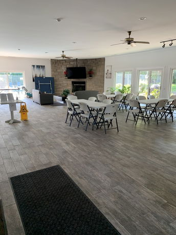 Indoor common area with seating and a fireplace.