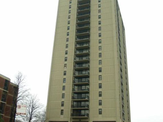 Front view of a high-rise building with multiple balconies.