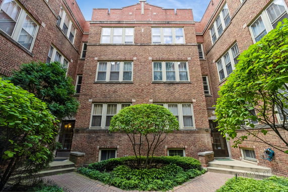 Front view of a multi-story brick apartment building.