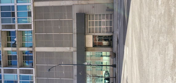 Front view of a multi-story building with modern design and glass facade.