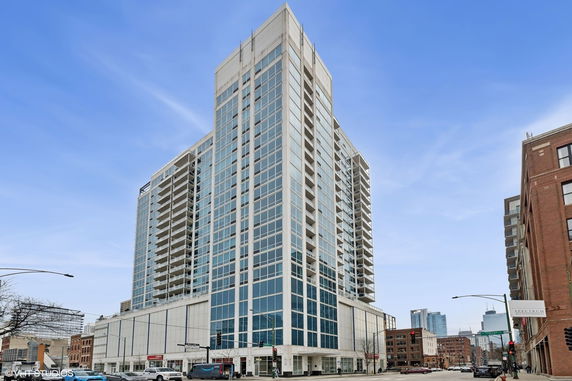 Front view of a modern high-rise building with glass windows.