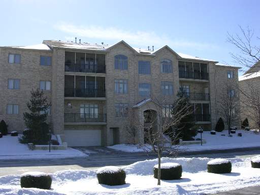 Front view of a multi-story residential building with balconies.