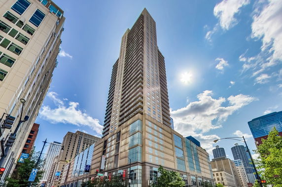 Front view of a tall skyscraper with a modern design.