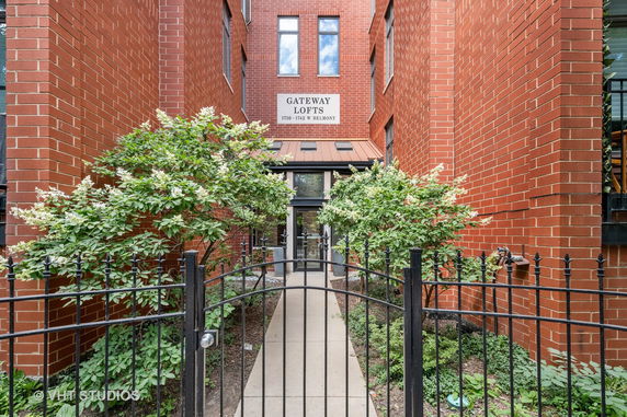 Front view of a brick building labeled Gateway Lofts.