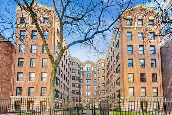 Front view of a multi-story brick apartment building.
