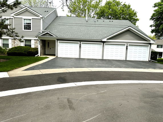 Front view of a two-story house with a four-car garage.
