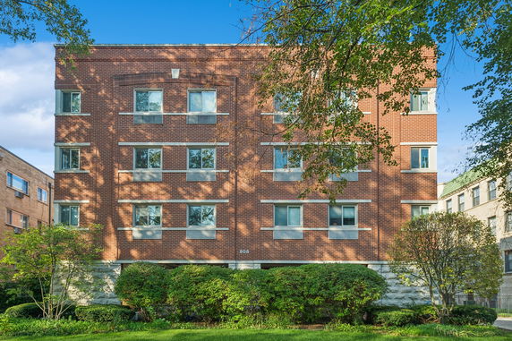 Front view of a multi-story brick apartment building.