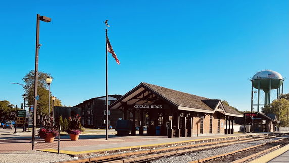 Front view of a train station building labeled 'Chicago Ridge' with a peaked roof.