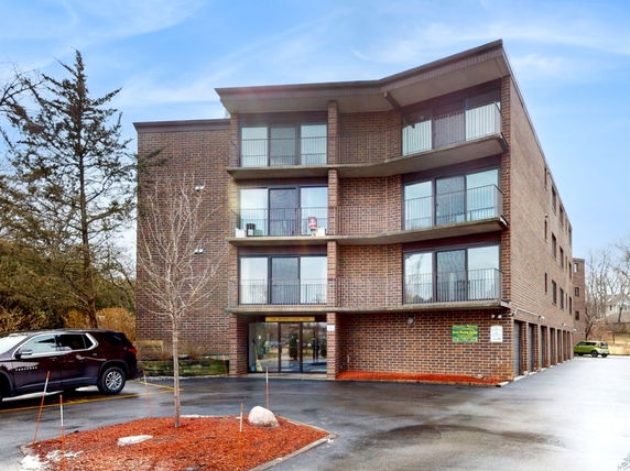 Front view of a multi-story brick apartment building.