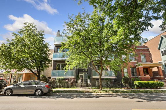 Front view of a multi-story residential building with balconies.