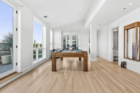 Recreation area with a pool table and wooden flooring