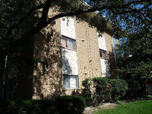 Front view of a multi-story brick building.