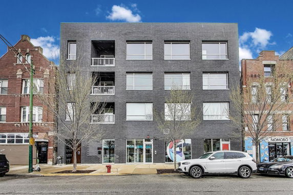Front view of a multi-story building with a modern facade.