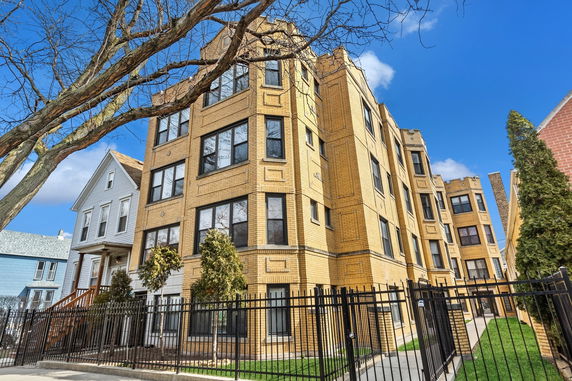 Front view of a multi-story brick apartment building.