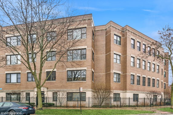 Front view of a multi-story brick apartment building.