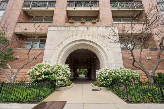 Front view of a multi-story building with an archway entrance.