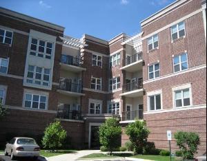 Front view of a multi-story brick apartment building.
