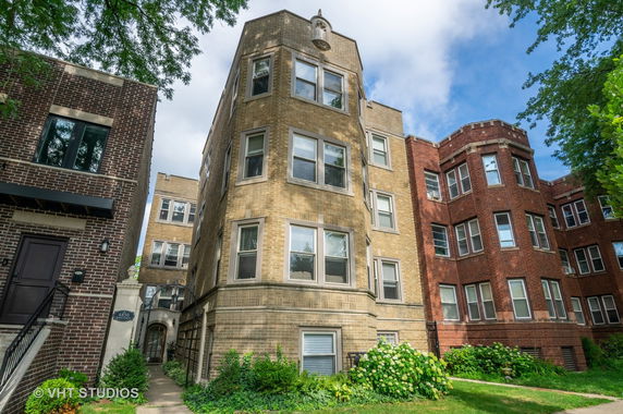 Front view of a multi-story apartment building with brick exterior.