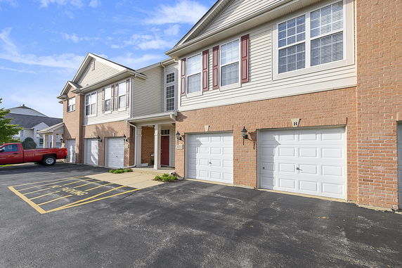 Front view of a townhouse with attached garages.