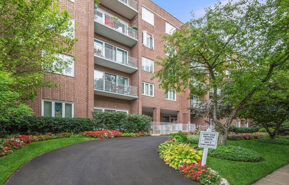 Front view of a multi-story brick building with balconies.
