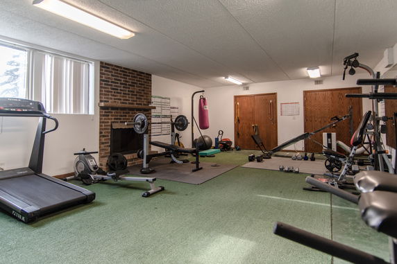 Interior view of a gym area with exercise equipment.