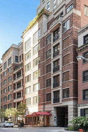 Front view of a multi-story brick apartment building.