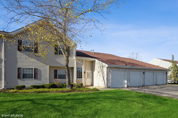 Front view of a two-story house with a multi-car garage.