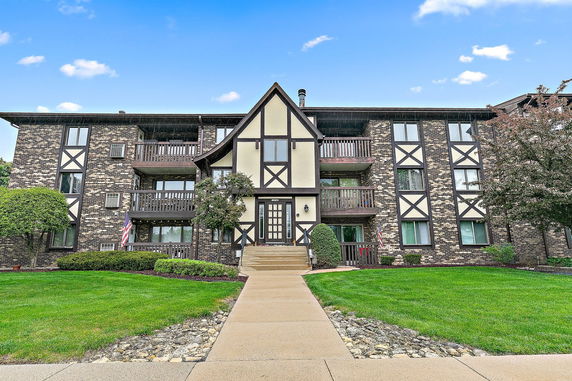 Front view of a multi-story building with Tudor architectural design.