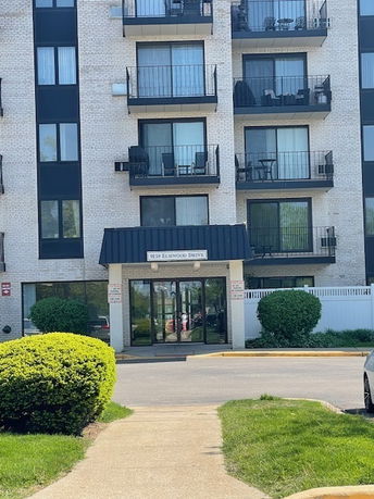 Front view of a multi-story apartment building with balconies.