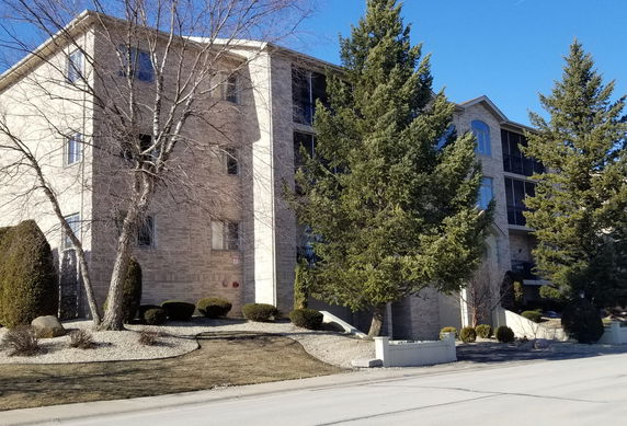 Front view of a multi-story residential building with a brick exterior.